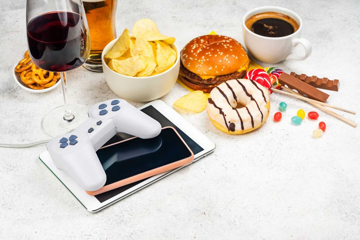 Stock photo of addictive items -- coffee, food, alcohol, tablets.