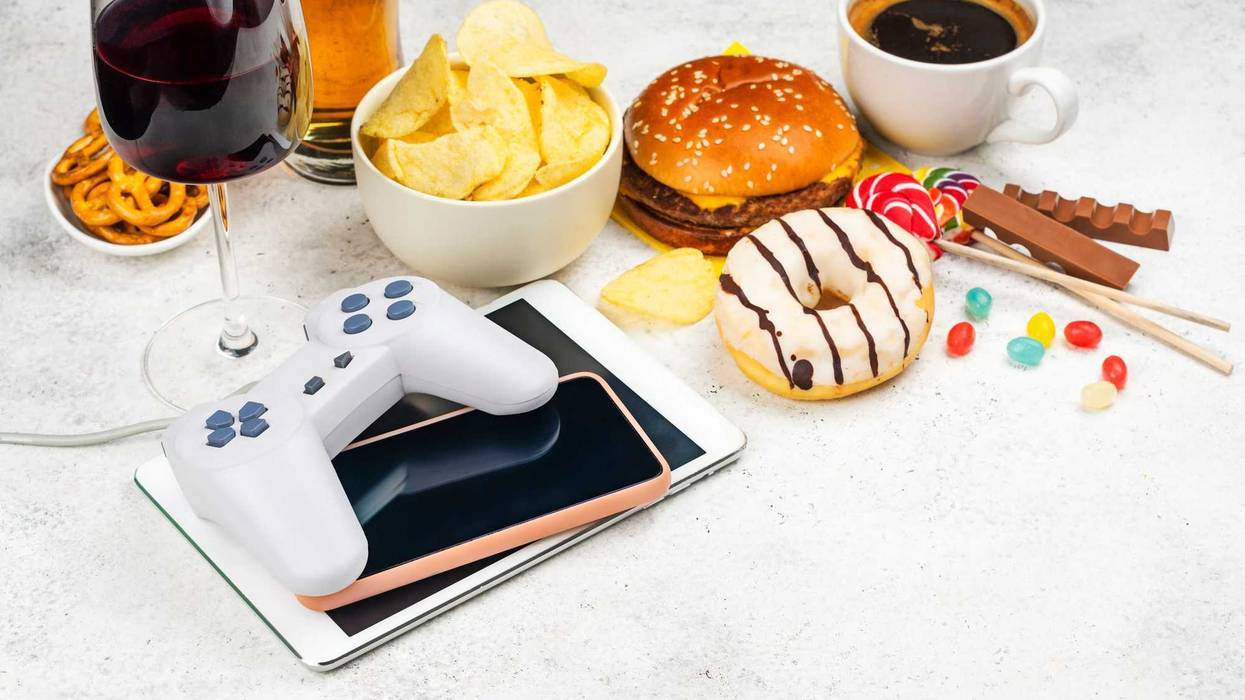 Stock photo of addictive items -- coffee, food, alcohol, tablets.