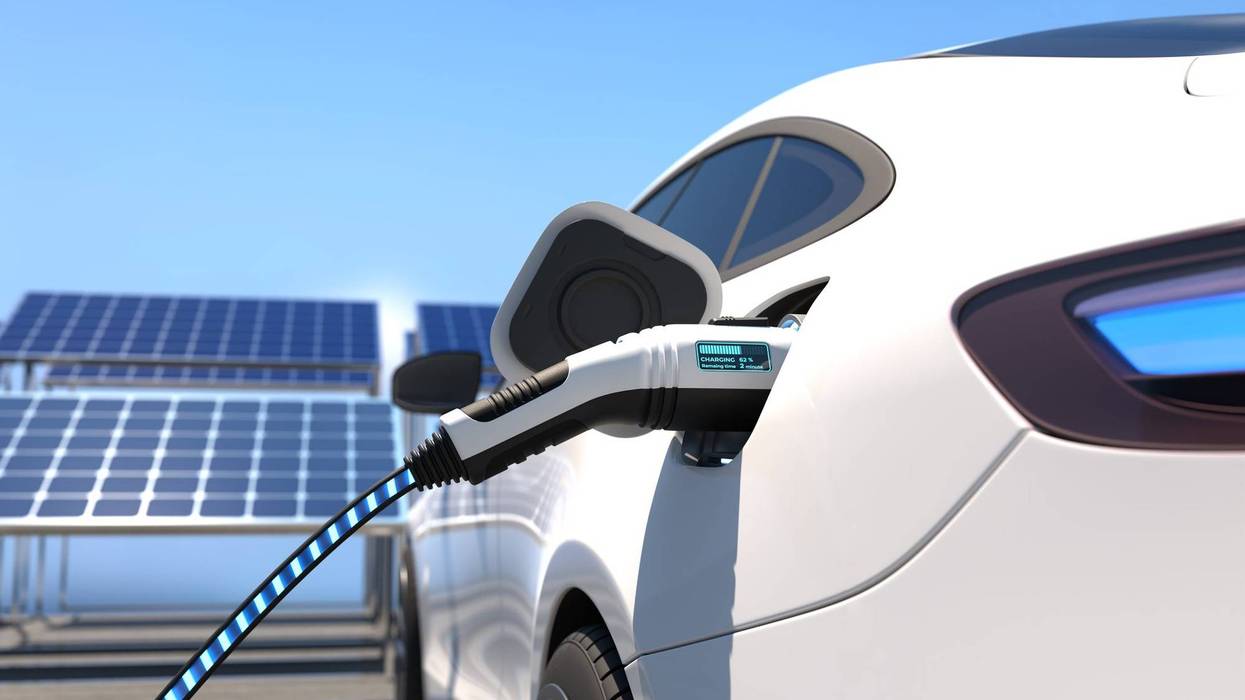Stock photo of electric vehicle on charger