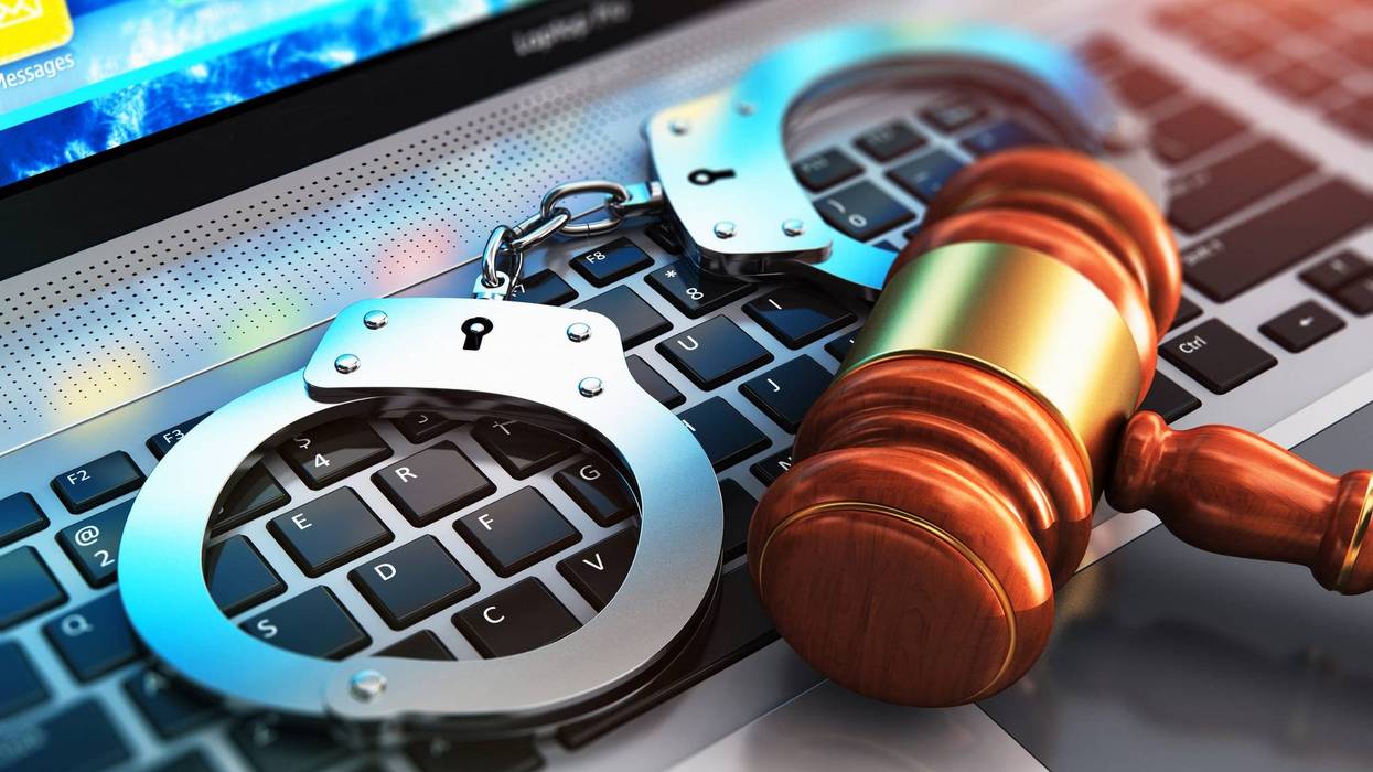 Stock photo of gavel, handcuffs and laptop
