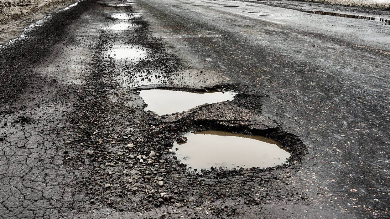Stock photo of potholes on road