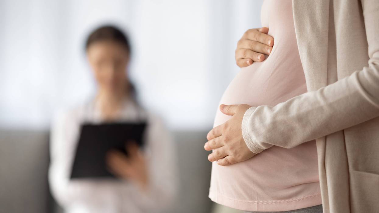 Stock photo of pregnant woman with doctor