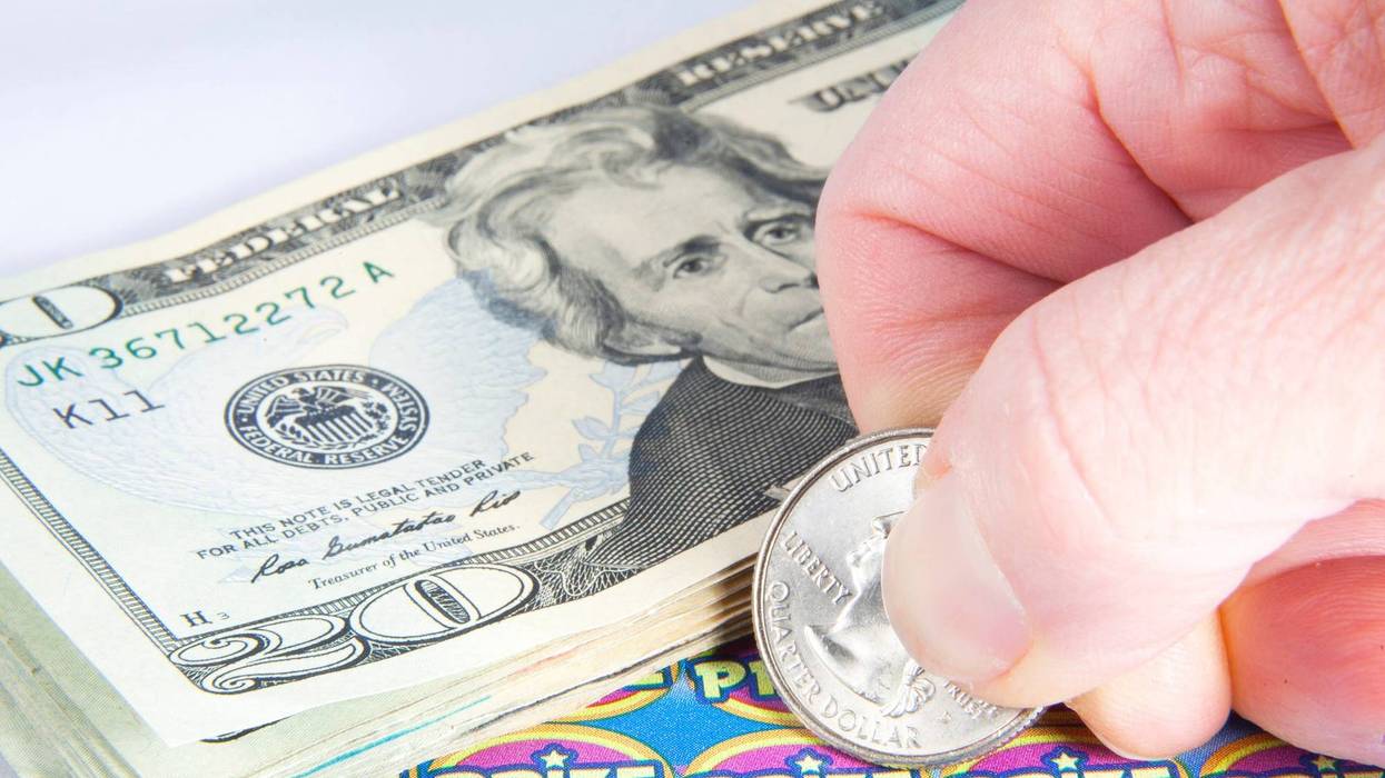 Stock photo of scratch-off lottery ticket and money