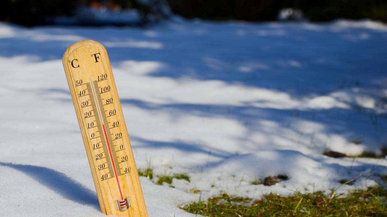 Stock photo of thermometer in melting snow