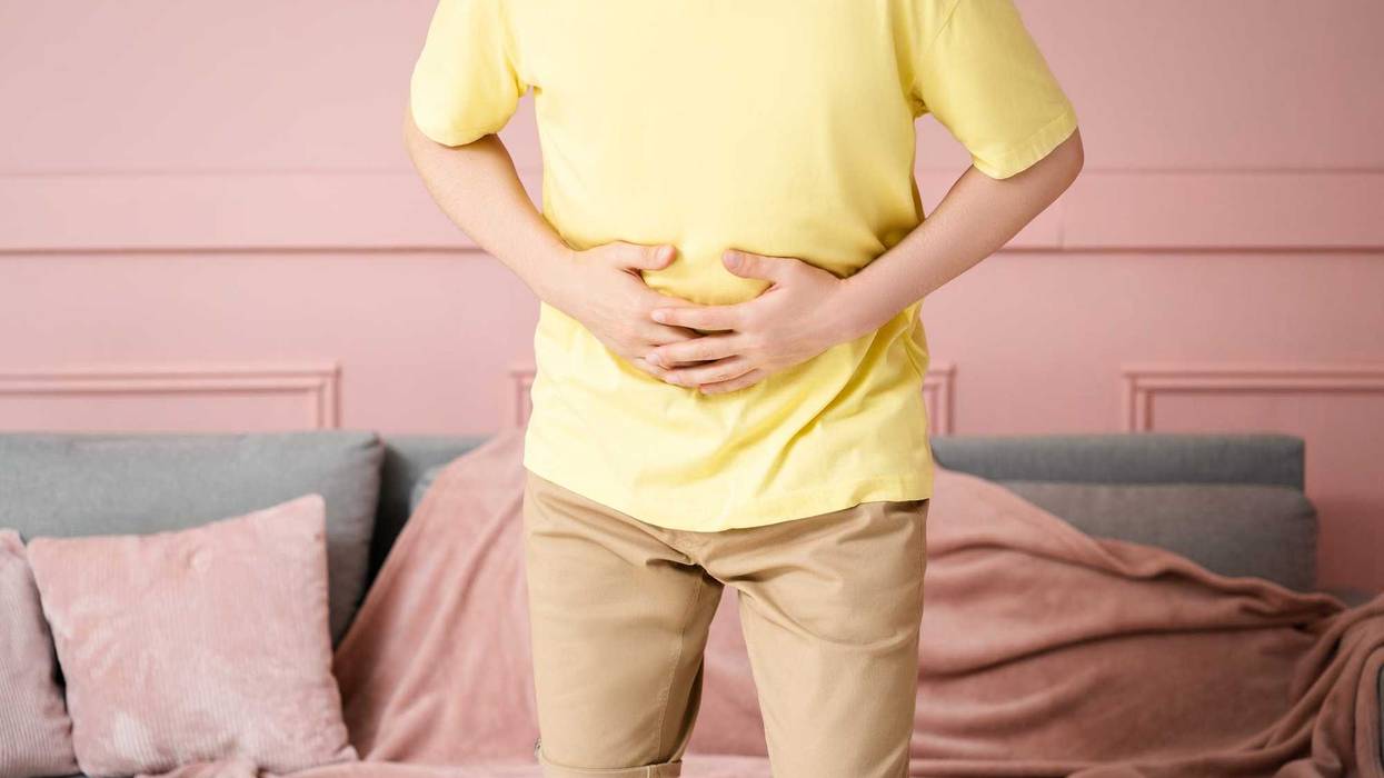 Stomach ache, man with abdominal pain suffering at home, health problems concept