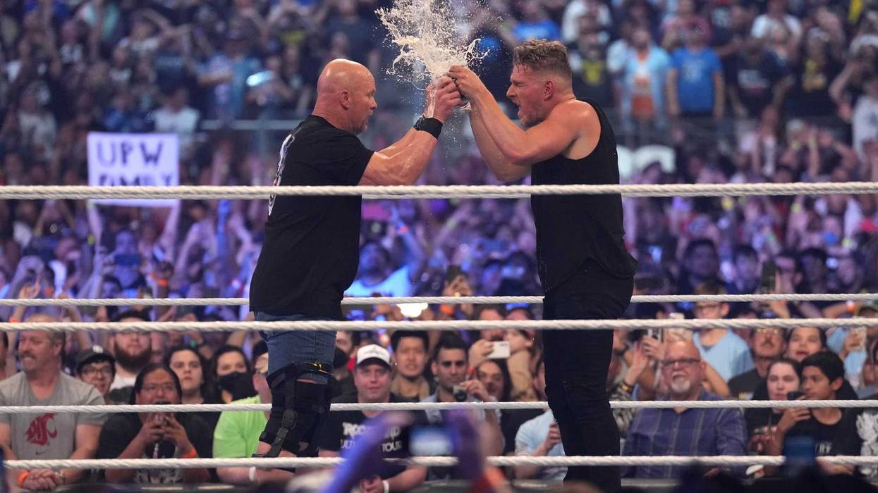 Stone Cold Steve Austin (left) and Pat McAfee toast beer during WrestleMania at AT&T Stadium