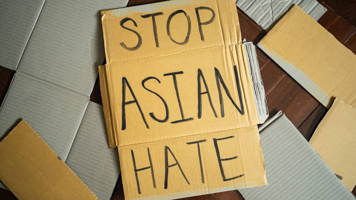 Stop Asian Hate written on cardboard.