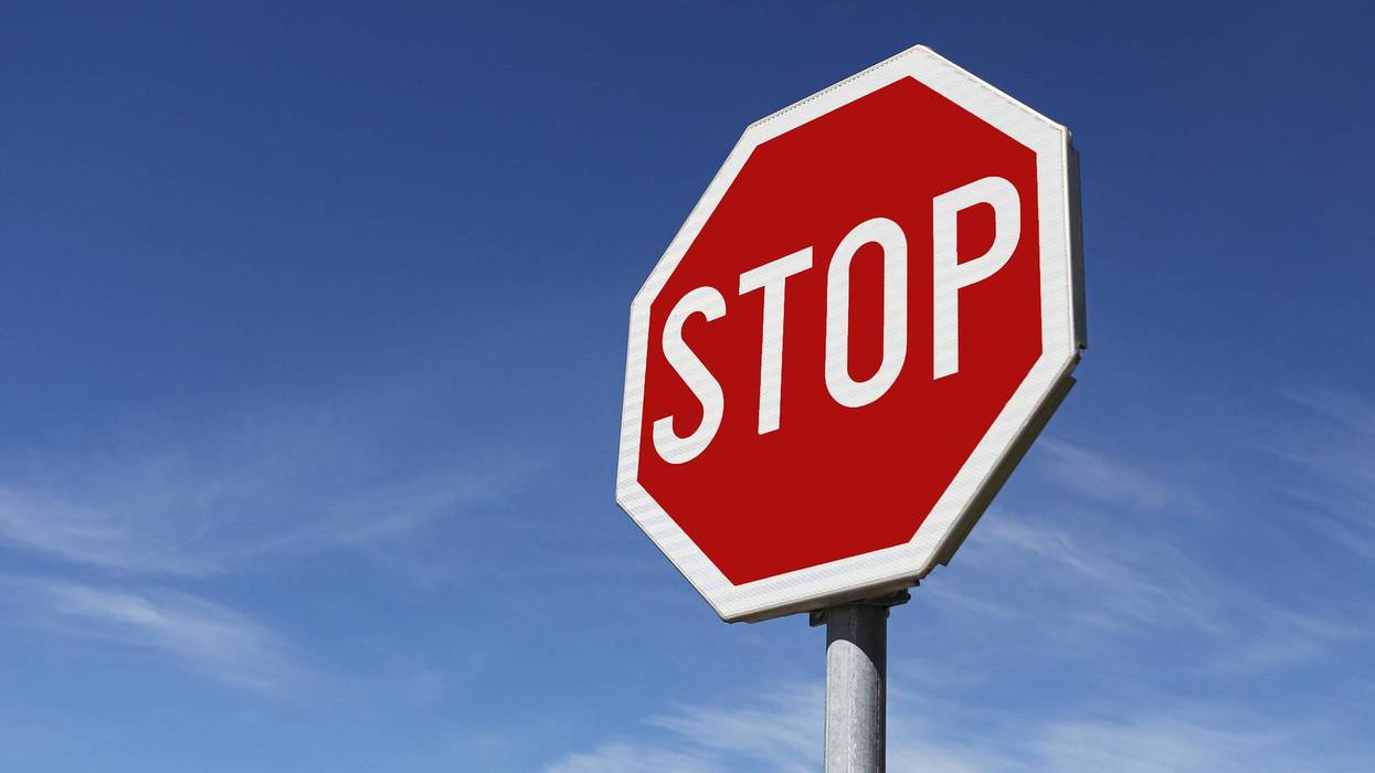 Stop traffic sign against blue sky. Road safety symbol with red octagon sign clear background