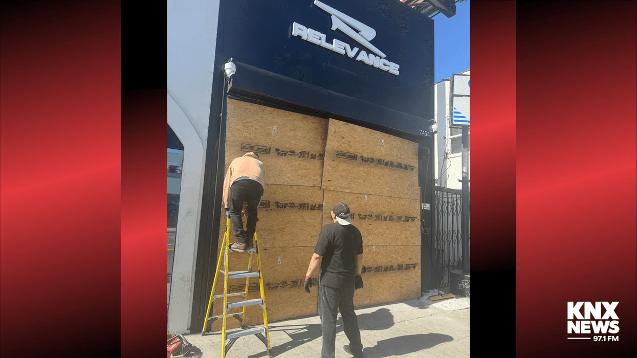 Storefront being boarded up after ransacked by burglars
