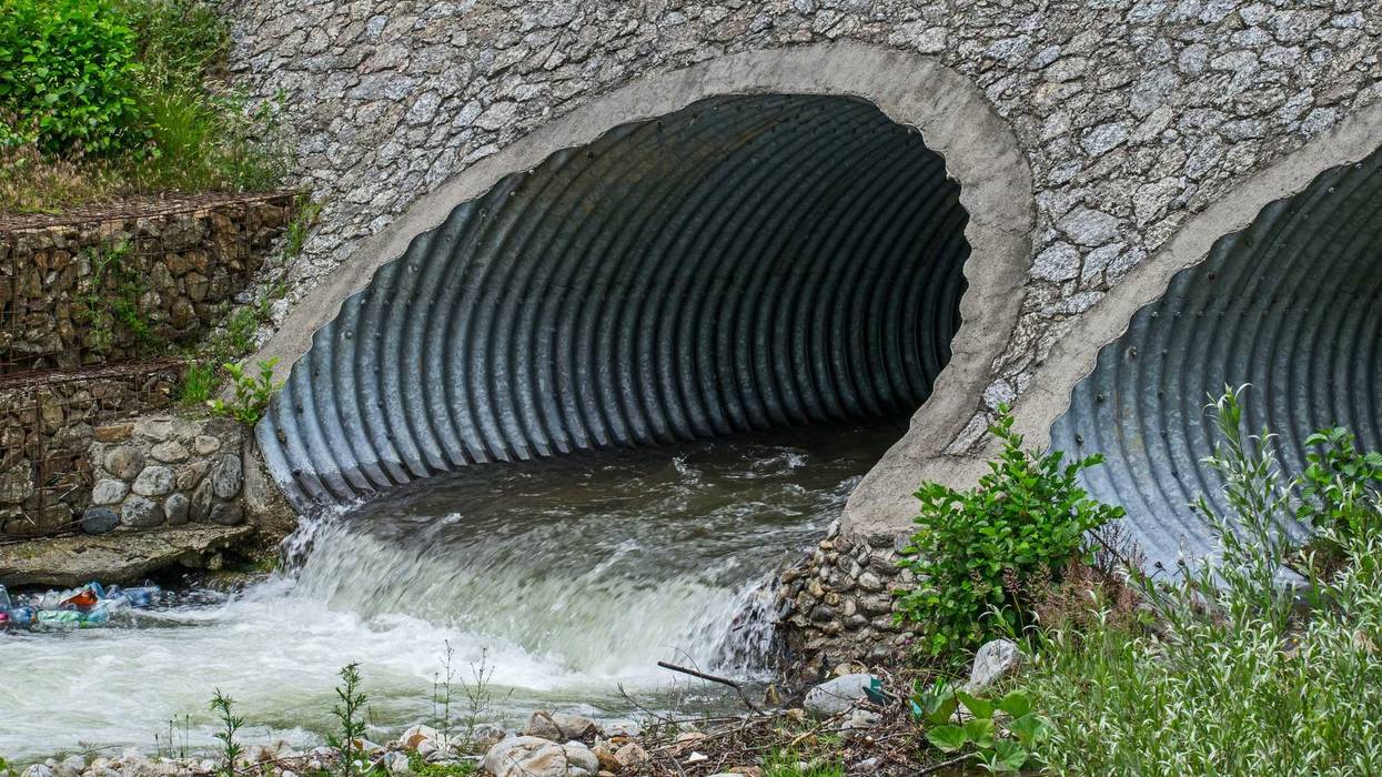 Storm drain under a bridge.