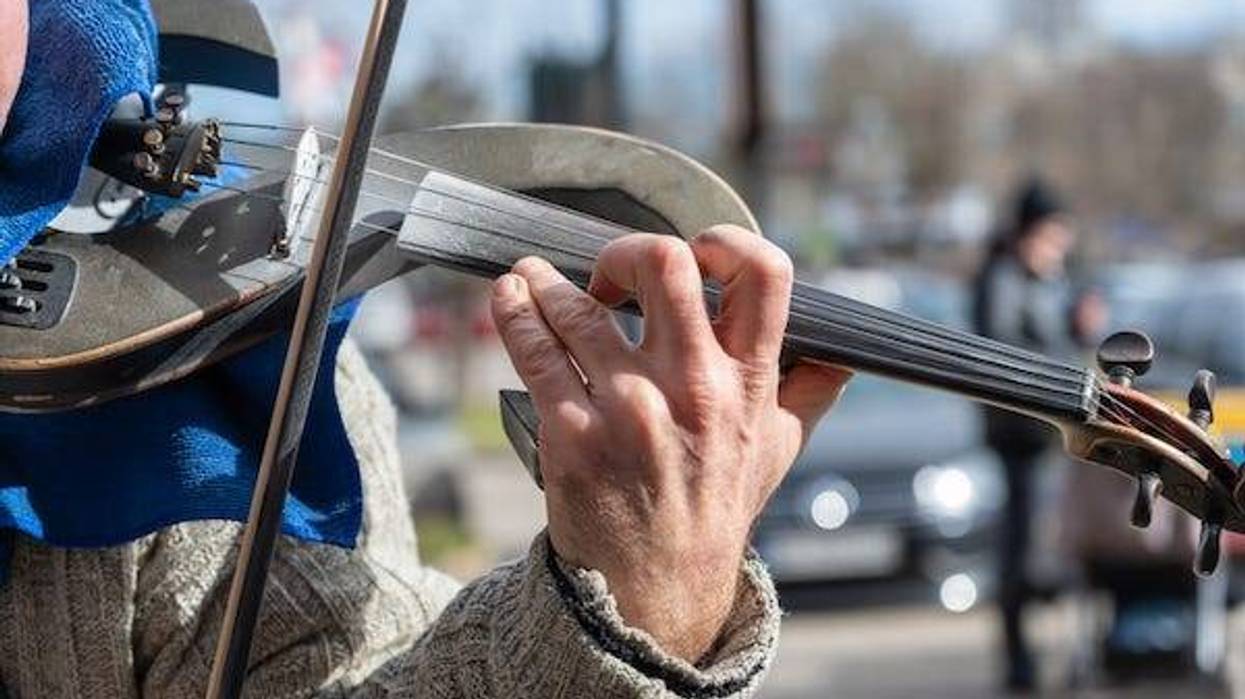 Street musician playing in parking lot