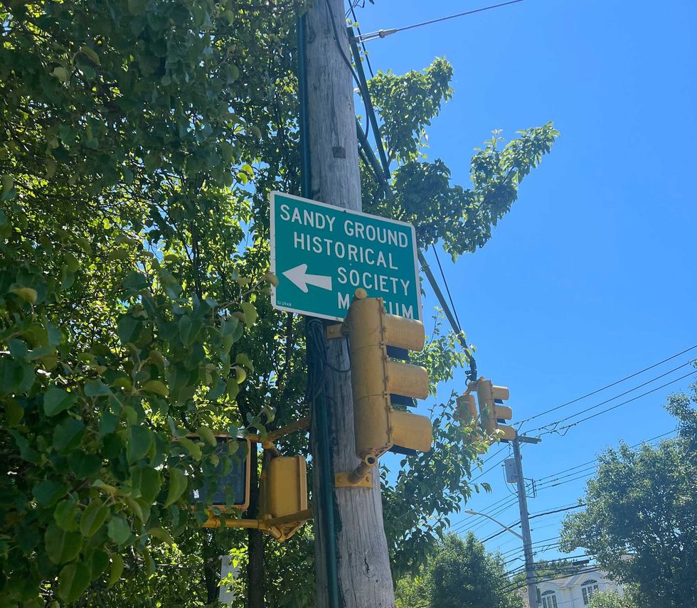 Street sign directing visitors to Sandy Ground museum