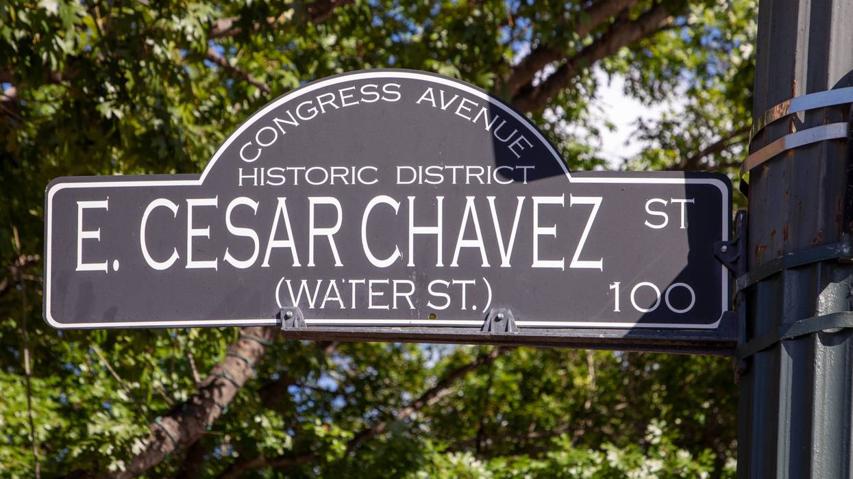 Street sign for E. Cesar Chavez St. in the Congress Avenue Historic District in Austin, Texas.