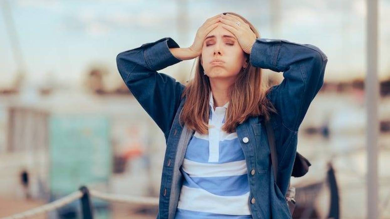 Stressed woman with her hands on her head