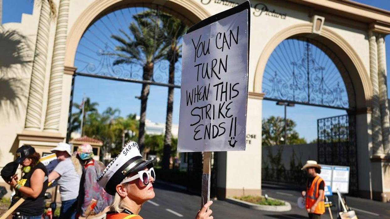 Strike captain SAG-AFTRA member Cari Ciotti holds a sign as SAG-AFTRA members and supporters picket outside Paramount Studios on day 113 of their strike against the Hollywood studios on November 3, 2023 in Los Angeles, California.