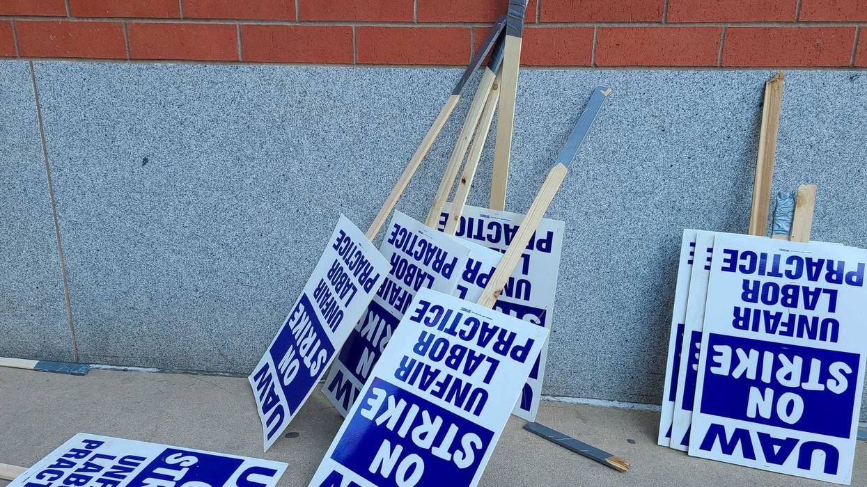 Strike signs resting on the wall.