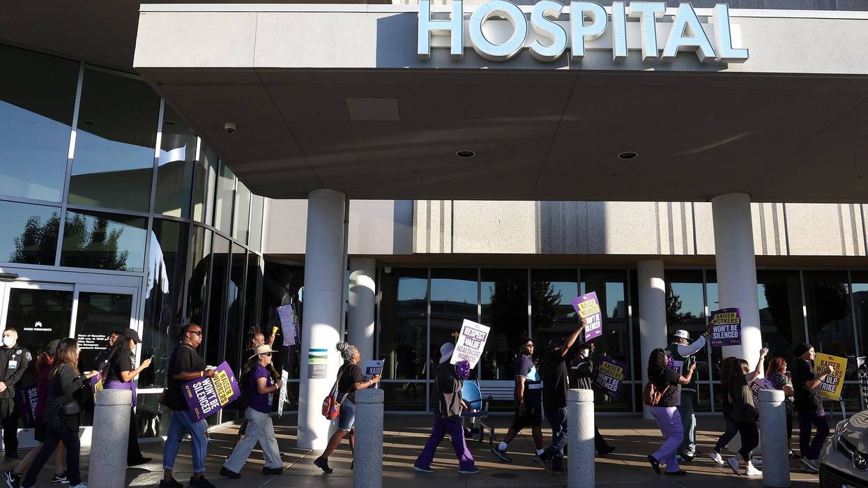 Striking Kaiser Permanente workers hold signs as they march in front of the Kaiser Permanente Vallejo Medical Center on October 06, 2023 in Vallejo, California.