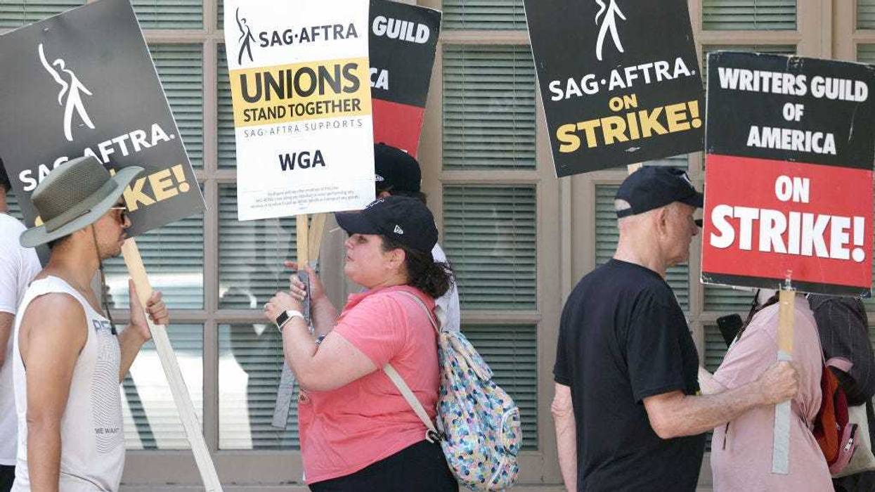 Striking SAG-AFTRA members picket with striking WGA (Writers Guild of America) workers on Day 5 outside Warner Bros. Studio on July 17, 2023 in Burbank, California.