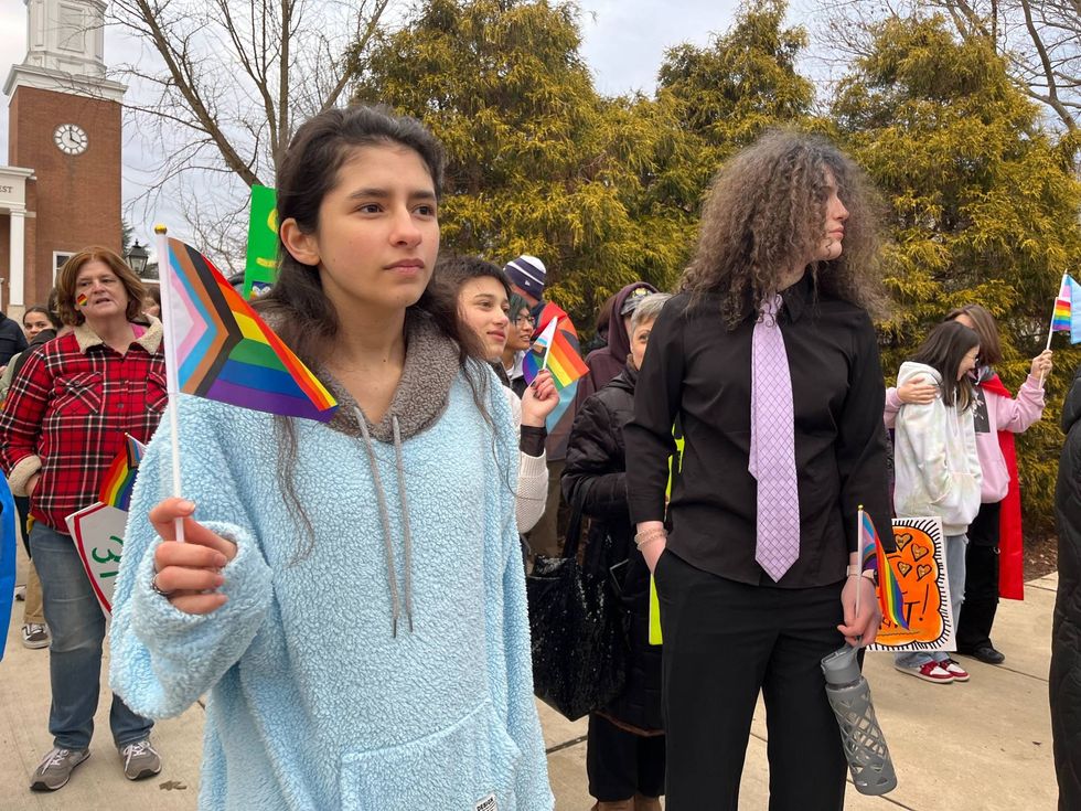 student holding pride flag
