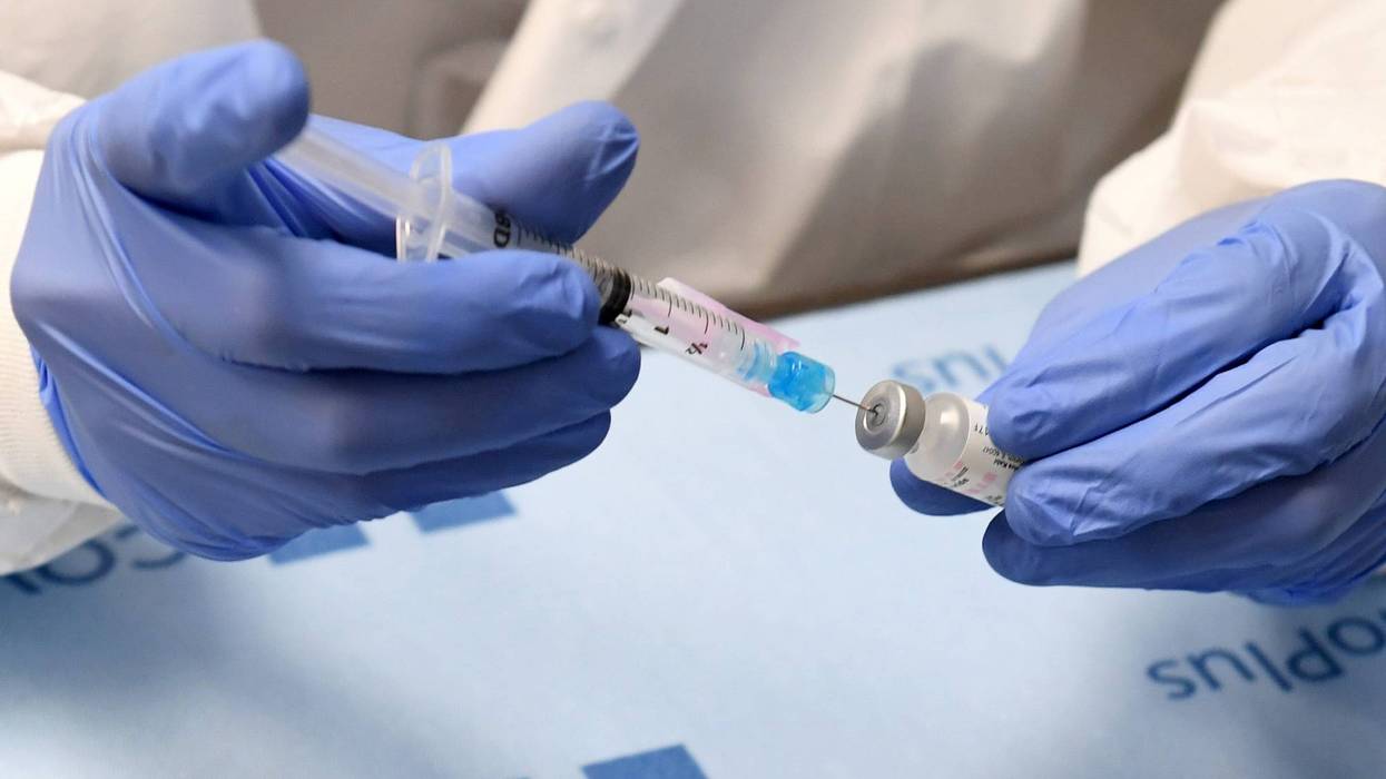 Student pharmacist Wilbur Quimba dilutes vials of the Pfizer-BioNTech COVID-19 vaccine at University Medical Center of Southern Nevada on December 16, 2020, in Las Vegas, Nevada.