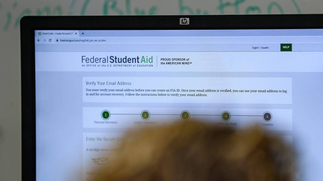 Students and families complete FAFSA forms online during an assistance event