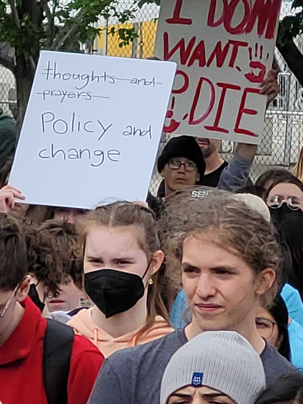 Students hold up signs during a gun violence protest in May 2022