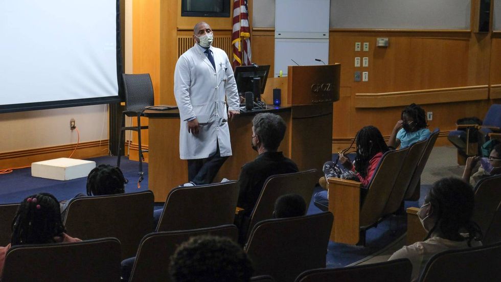 Students learning from Dr. Thomas Butler, who started the initiative