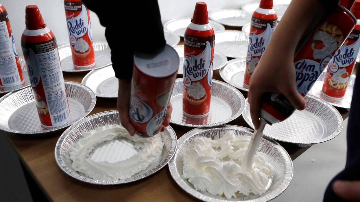 Students prepare whipped cream pies before a celebration of pi at the Hamtramck Academy Tuesday, March 14, 2017, in Hamtramck, Mich. On Friday, Sept. 2, 2022, The Associated Press reported on stories circulating online incorrectly claiming a New York law that aims to crack down on nitrous oxide abuse makes it illegal for anyone under age 21 to purchase a can of whipped cream.