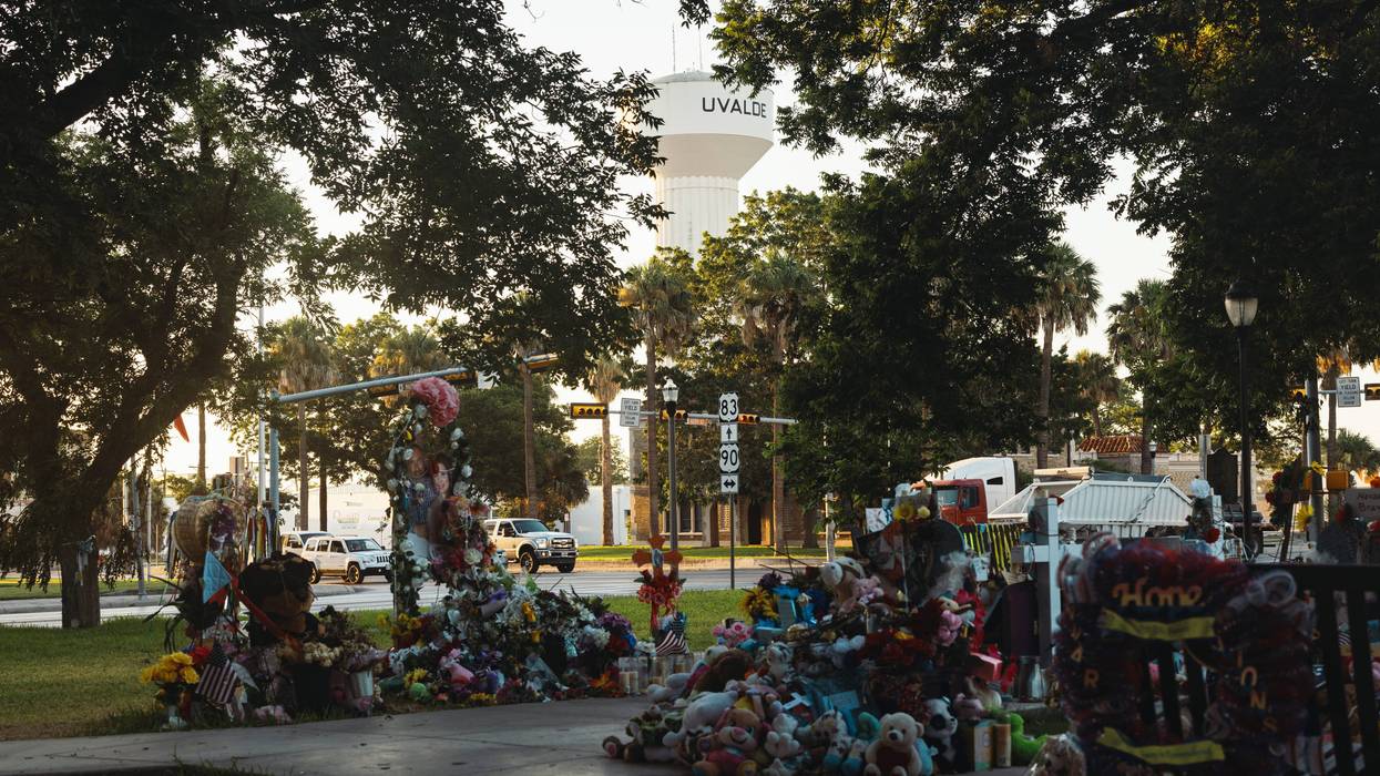 Stuffed animals, flowers, and other keepsakes are left next to crosses bearing the names of the victims of the mass shooting at Robb Elementary School at a memorial in the town square on June 25, 2022, in Uvalde, Texas. The Uvalde community is marking one month since the deadly shooting where 19 students and 2 teachers were killed.