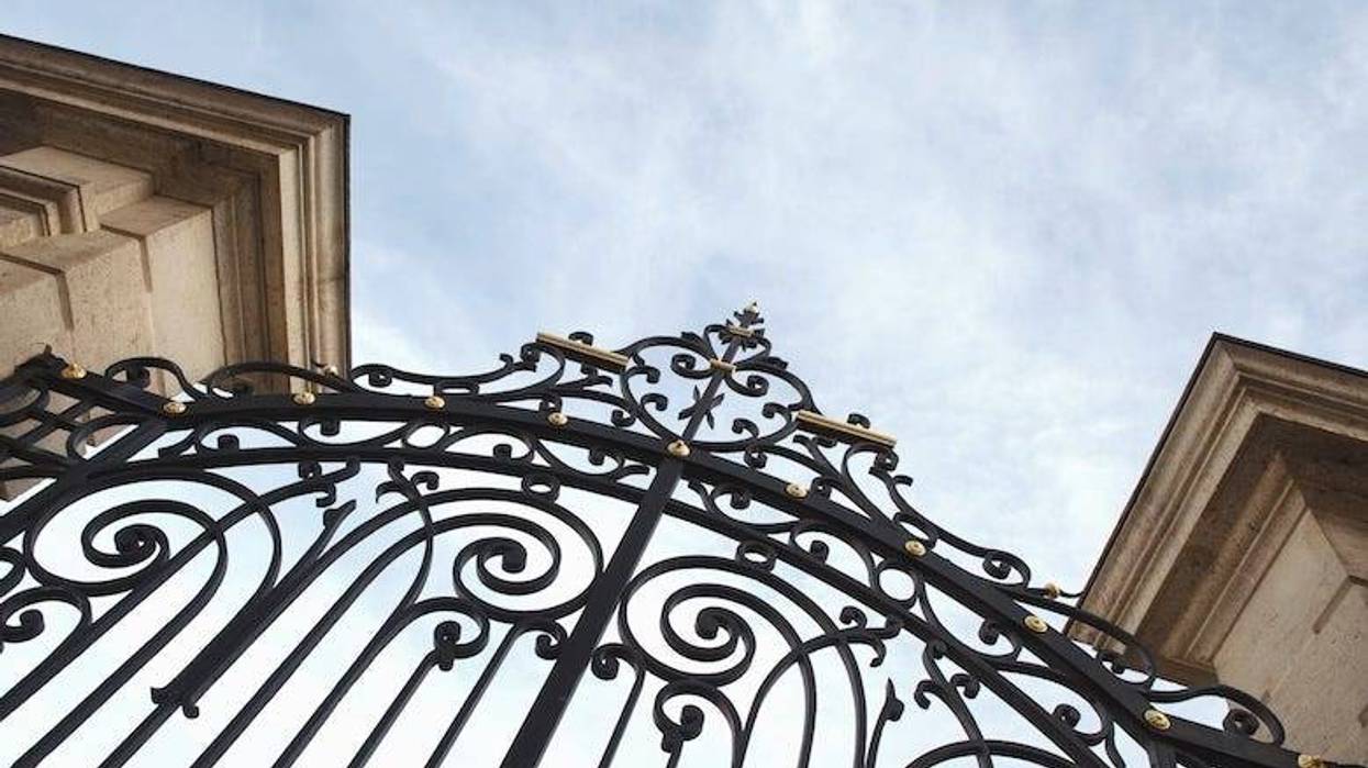 Stylish wrought iron gate and stone pillars