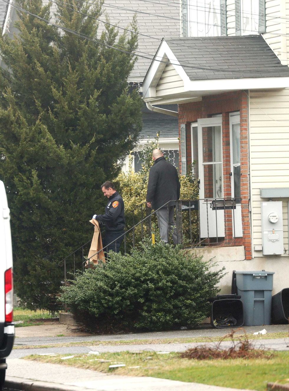 Suffolk County Police Crime Scene investigators are seen outside of a home on Railroad Avenue in Amityville on March 5, 2024