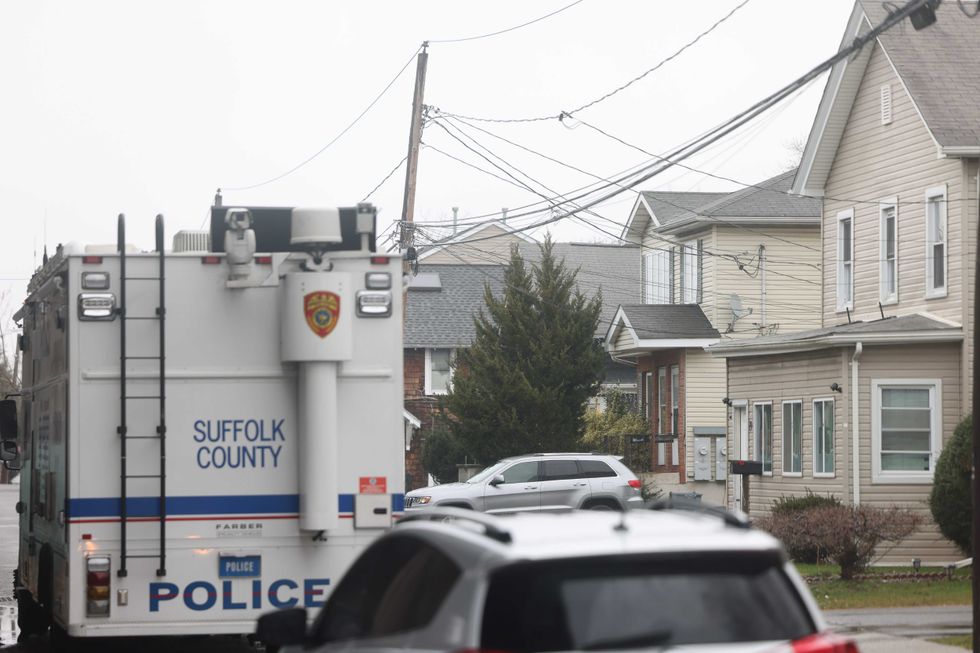 Suffolk County Police Crime Scene investigators are seen outside of a home on Railroad Avenue in Amityville on March 5, 2024