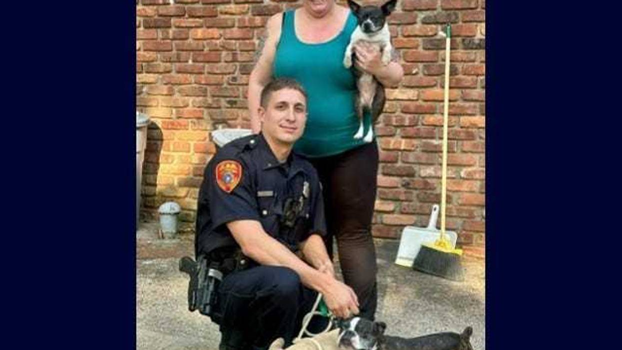 Suffolk County Police Officer Matthew Ingui and the three dogs he rescued from a Long Island house fire on Sunday.