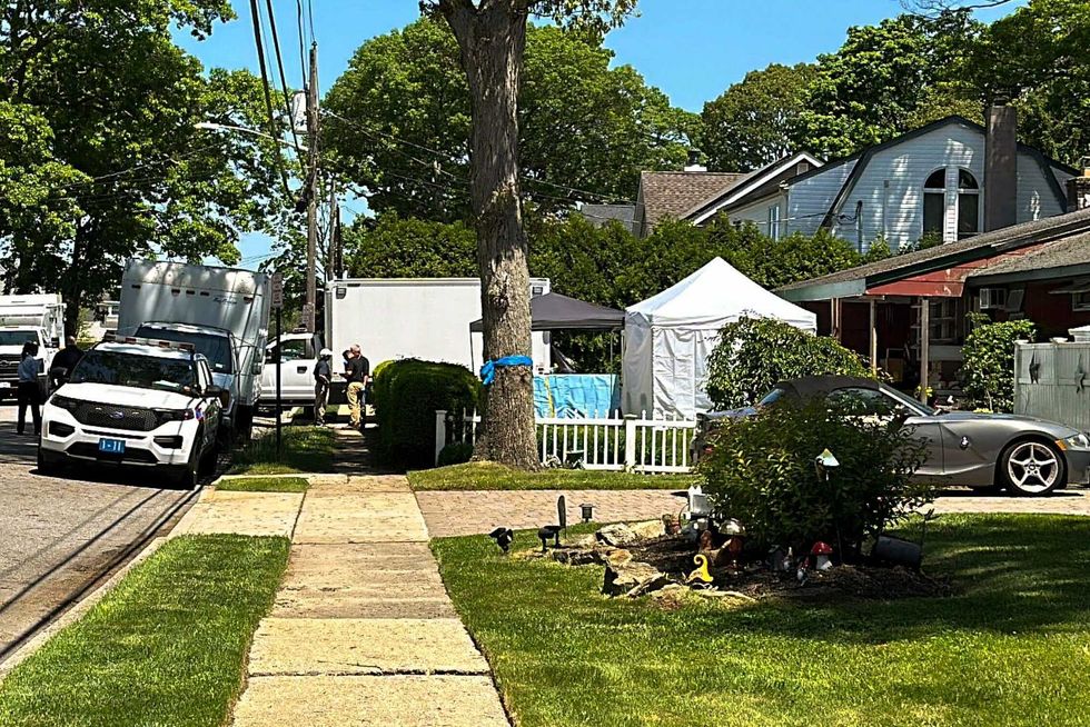 Suffolk County police stand outside the home of Rex Heuermann, Friday, May 24, 2024, in Massapequa Park
