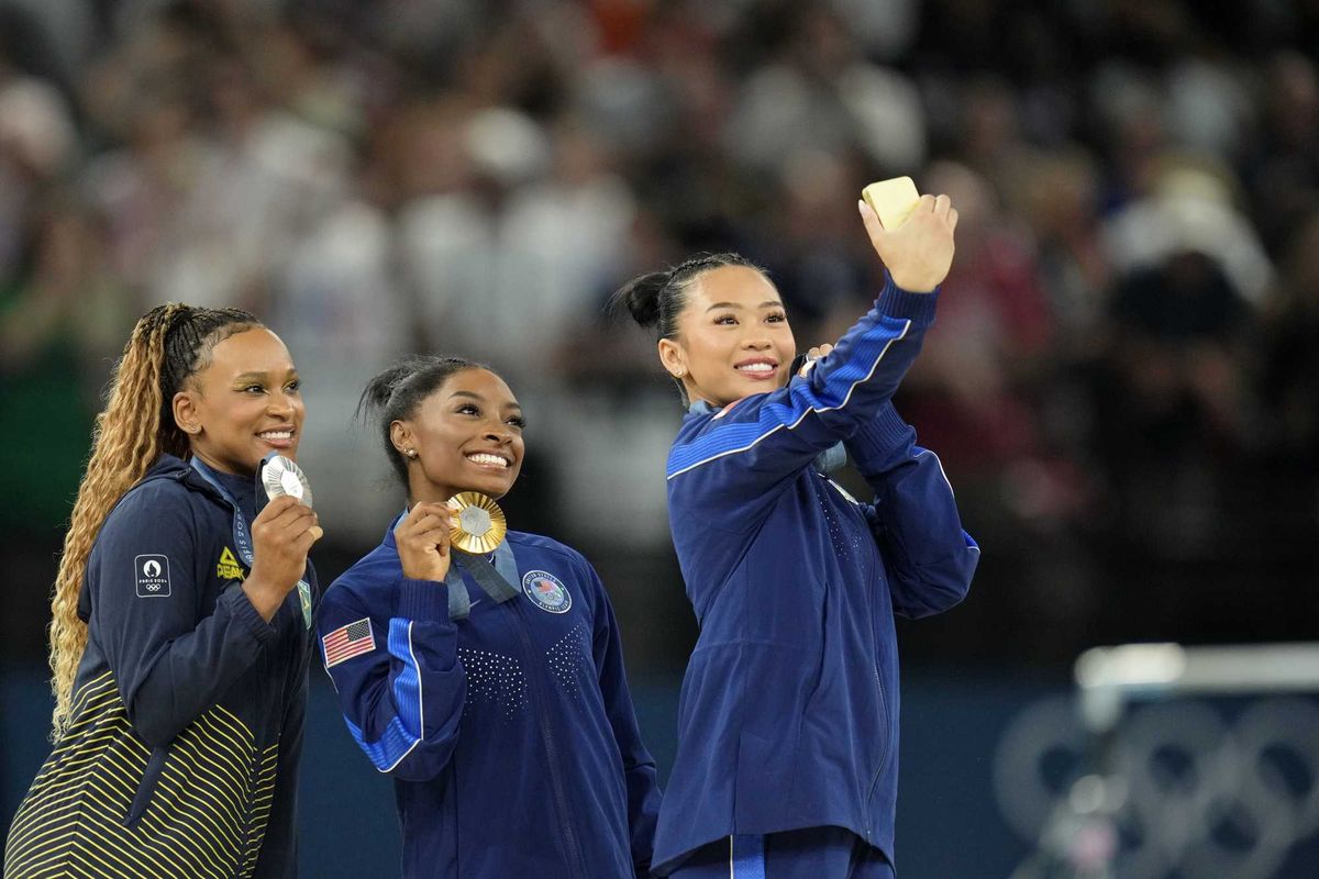Sunisa Lee of the United States posed for a photo with Rebeca Andrade of Brazil and Simone Biles and their medals in the women's gymnastics all-around during the Paris 2024 Olympic Summer Games at Bercy Arena.