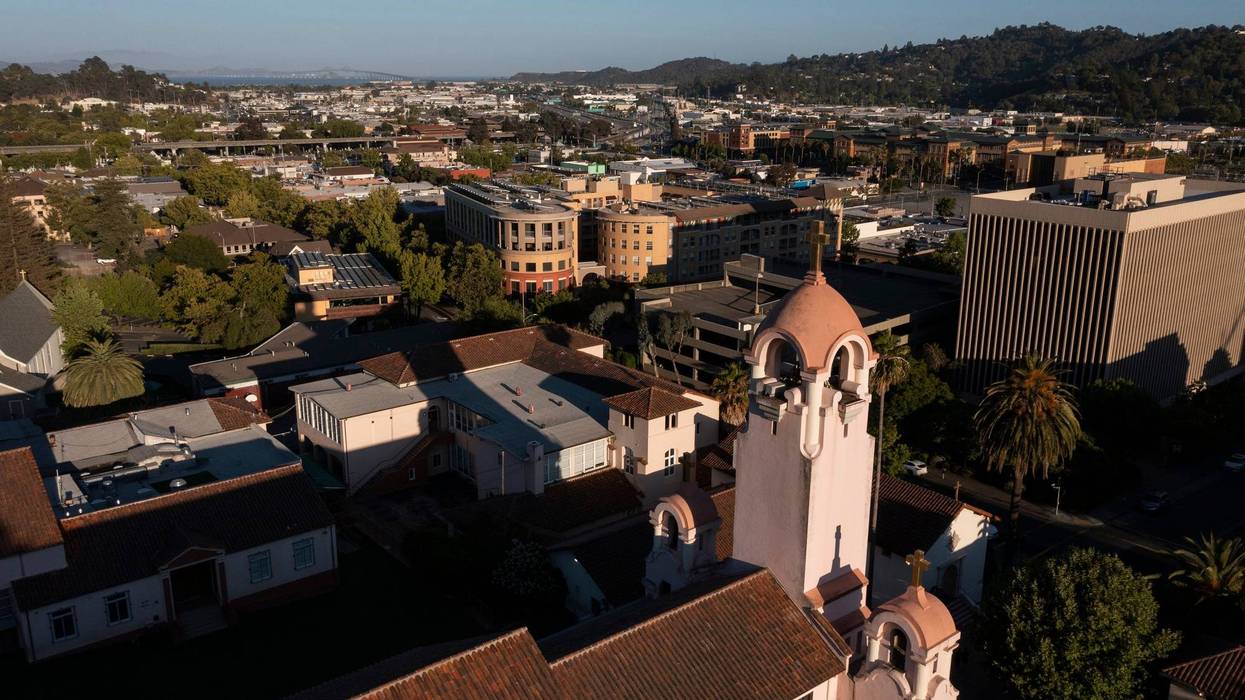 Sunset light shines on the historic Spanish Colonial mission and downtown skyline of San Rafael, California