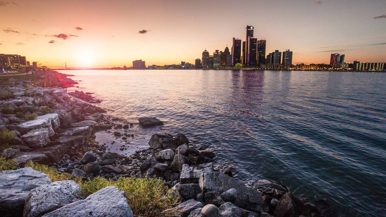 Sunset over Detroit skyline and river