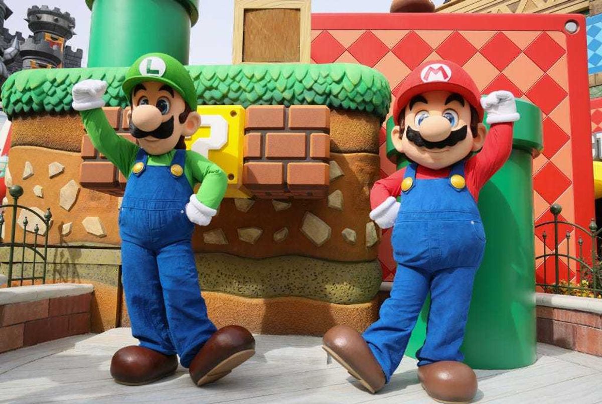 Super Mario Bros Luigi and Mario pose at the "SUPER NINTENDO WORLD" welcome celebration at Universal Studios Hollywood on February 16, 2023 in Universal City, California.