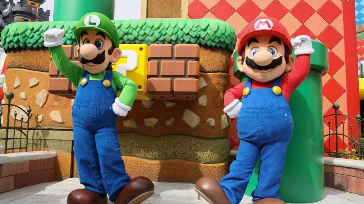 Super Mario Bros Luigi and Mario pose at the "SUPER NINTENDO WORLD" welcome celebration at Universal Studios Hollywood on February 16, 2023 in Universal City, California.