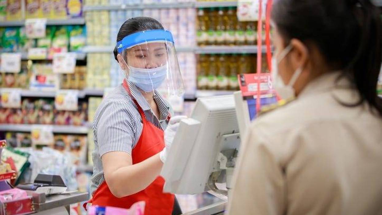 supermarket cashier in medical protective mask