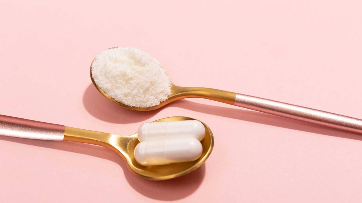 Supplements and powder on a pink background stock photo.