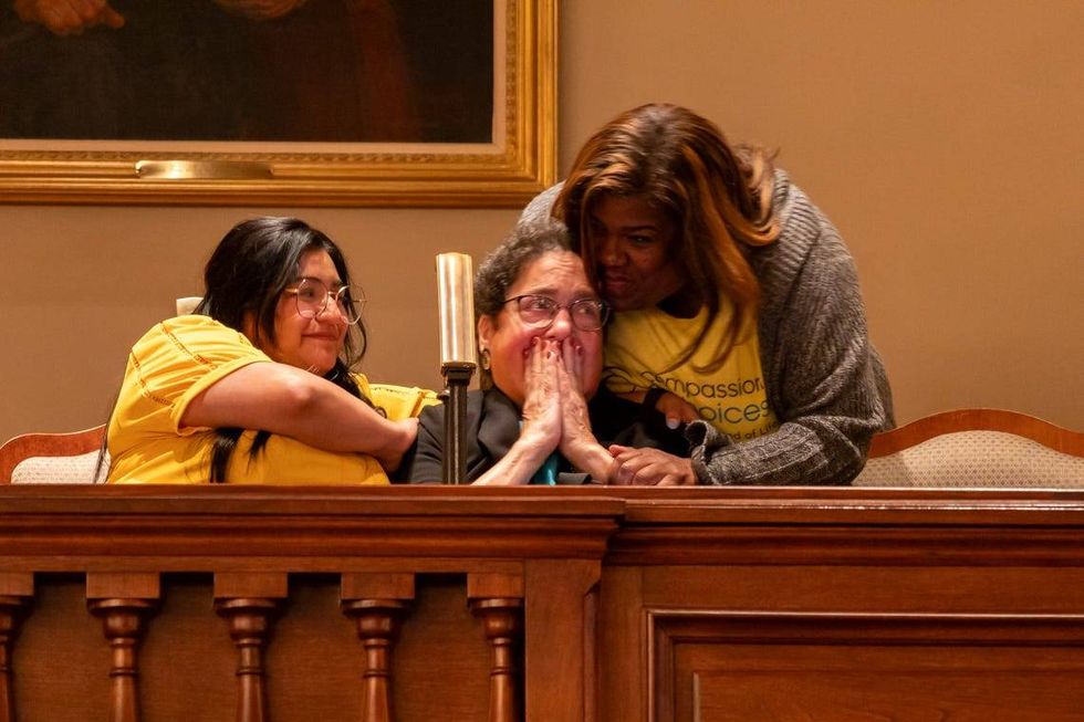 Supporters of a bill to legalize "medical aid in dying" cry as it passes in the Illinois House on Thursday. Pictured left to right: Daisy Orihuela, Amy Sherman and Donna Smith.