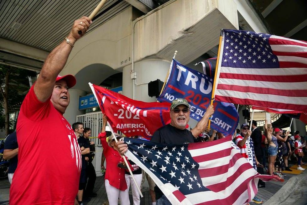 Supporters of former President Donald Trump cheer after he arrived at the Wilkie D. Ferguson Jr. U.S. Courthouse, Tuesday, June 13, 2023, in Miami. Trump appeared in federal court on dozens of felony charges accusing him of illegally hoarding classified documents and thwarting the Justice Department
