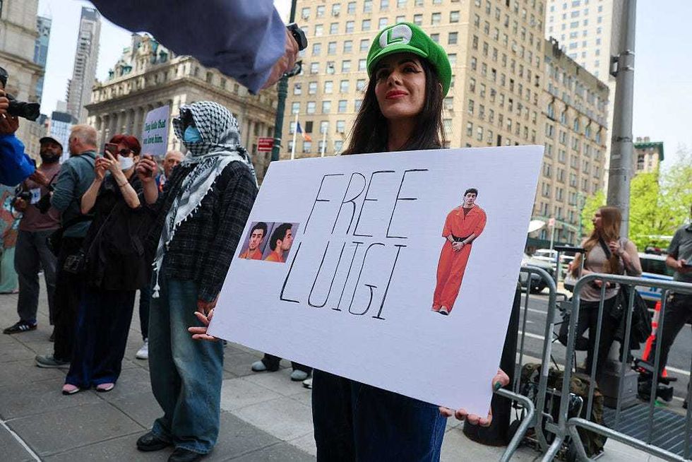 Supporters of Luigi Mangione gather outside a federal court in Manhattan as the murder suspect is set to appear for the arraignment on charges that he murdered UnitedHealthcare CEO Brian Thompson late last year on April 25, 2025 in NYC.