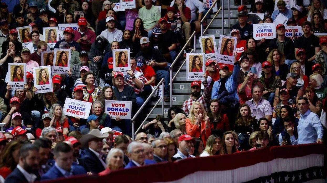 Supporters of Republican presidential candidate and former U.S. President Donald Trump hold up posters with the image of Laken Riley during at a campaign rally for Trump at the Forum River Center March 09, 2024 in Rome, Georgia. Laken Riley, 22, was a University of Georgia student who was murdered on February 22 and police have arrested an undocumented immigrant for the crime. Both Trump and President Joe Biden are holding campaign events on Saturday in Georgia, a critical battleground state, two days before the its primary elections. (Photo by Chip Somodevilla/Getty Images)