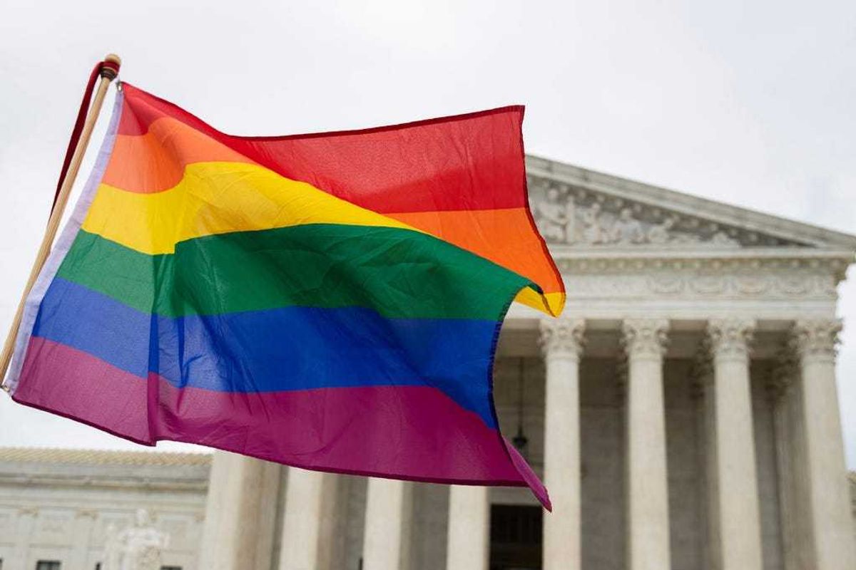 Supporters of the LGBT wave their flag in front of the U.S. Supreme Cour, Oct. 8, 2019, in Washington.