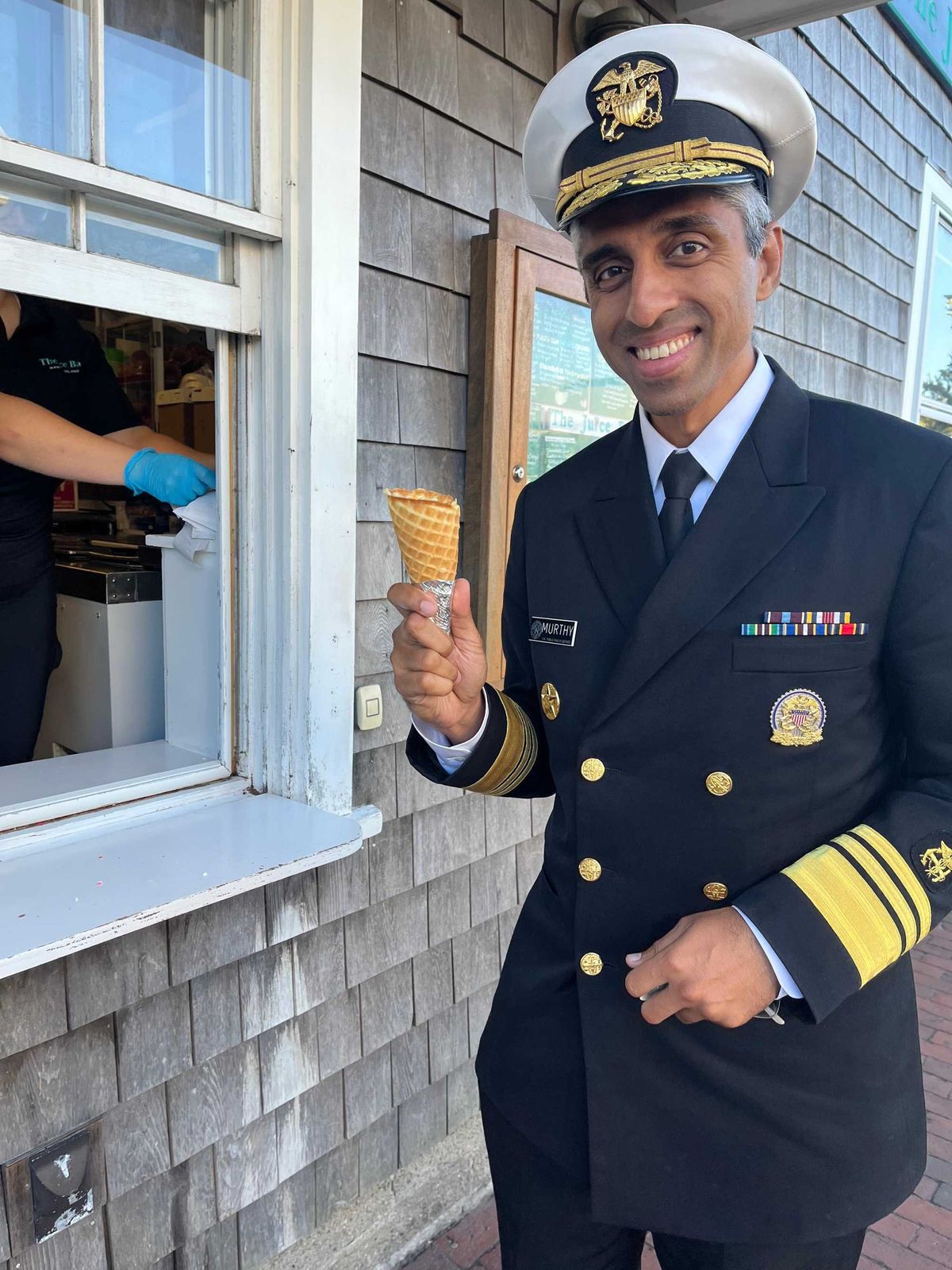 Surgeon General Vivek Murthy ordering an ice cream cone, sans ice cream.