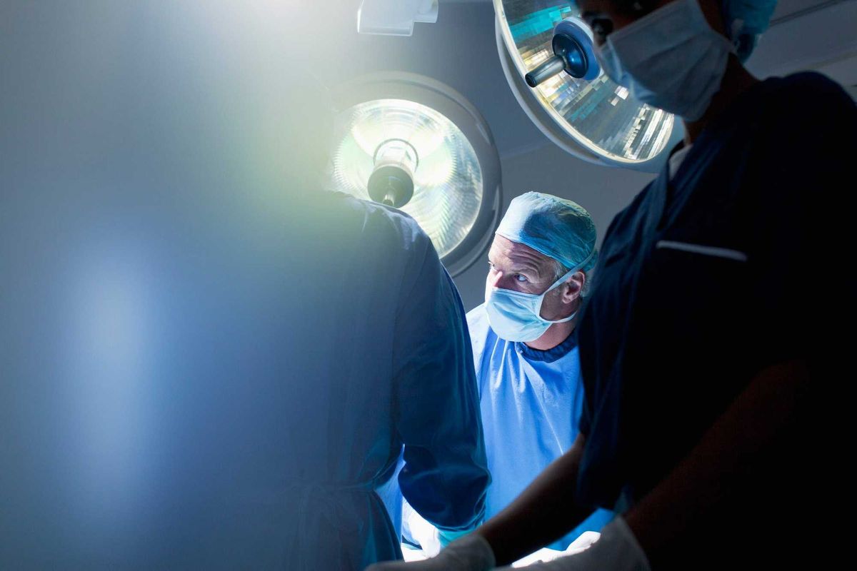 Surgeons in an operating room stock photo.