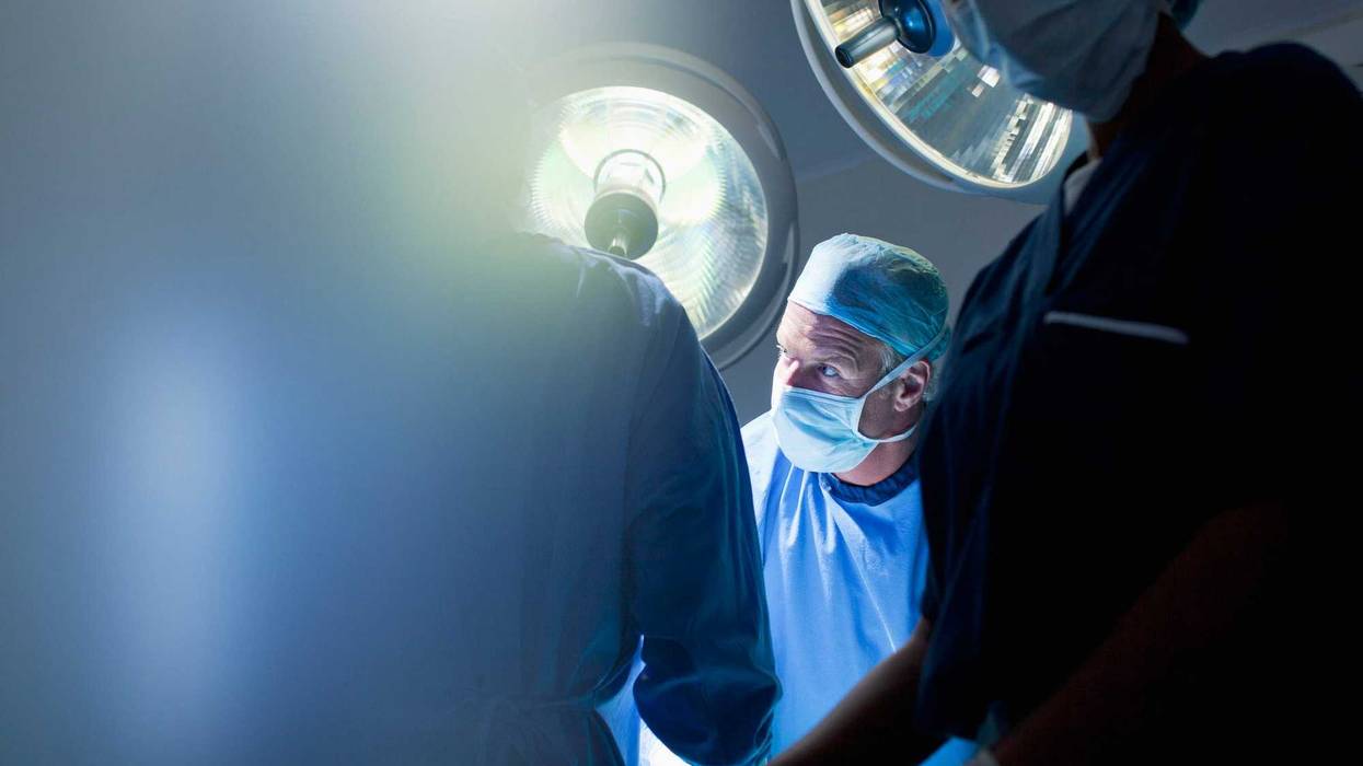 Surgeons in an operating room stock photo.
