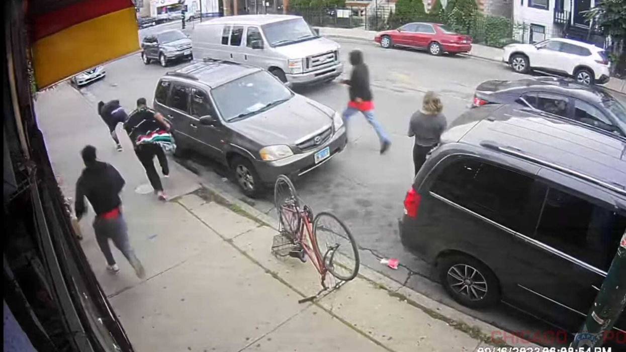 Surveillance footage shows five people on the street during the scene of a shooting.